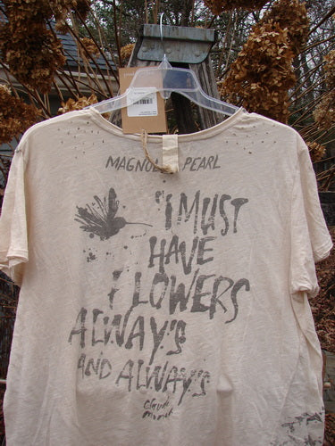 Magnolia Pearl NWT Cotton Jersey Boyfriend Tee Always & Always Moonlight OSFA, featuring distressed detailing, a vintage bird and quote print, and rolled edges, hanging against dried foliage.