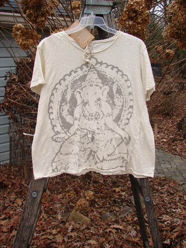 Magnolia Pearl NWT Cotton Jersey Boyfriend Tee Ganesh Moonlight OSFA features a distressed Ganesha print on soft cotton, displayed on a rustic ladder amidst leaves, emphasizing its vintage-inspired, artistic design.