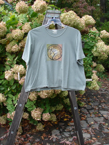 1999 Patched Short Sleeved Crop Tee, featuring a Tri Floral theme, displayed on a rack. Organic cotton, rolled neckline, and Blue Fish patch. Size 2, perfect condition, from the Summer Collection.