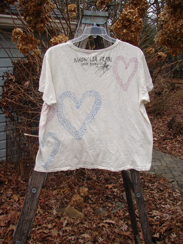 Magnolia Pearl NWT Cotton Jersey Boyfriend Tee Frida Del Sol True OSFA, featuring hand-drawn hearts and text, displayed on a wooden stepladder, reflecting Bluefishfinder.com's vintage and creative style.