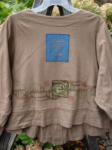 1997 Treehouse Jacket Primitive Climb Lumber Size 1 featuring a blue patch, double-paneled V neck, button line, draw cord flounce, and varying hemline, made from mid-weight organic cotton.