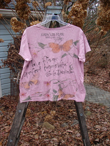 Magnolia Pearl NWT Cotton Jersey Boyfriend Tee Profound Responsibility Allium OSFA, featuring butterflies and foliage print, draped over a step-ladder, showcasing rolled edges and shoulder distressing amidst a natural backdrop.