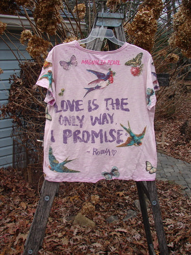 Magnolia Pearl NWT Applique Cotton Jersey Boyfriend Tee Love Is The Only Way Allium OSFA displayed on a ladder, showcasing colorful swallows, butterflies, and a bold slogan, emphasizing a relaxed, artistic style.