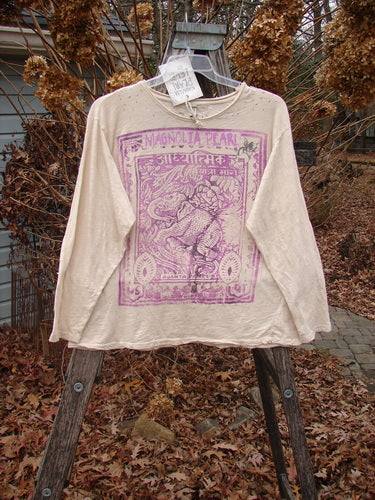 Magnolia Pearl NWT Cotton Jersey Boyfriend Tee Spiritual Walk Carousel OSFA hung outdoors. Features ornate purple elephant print, rolled edges, upper shoulder distressing, and diagonal seam, capturing artistic individuality.