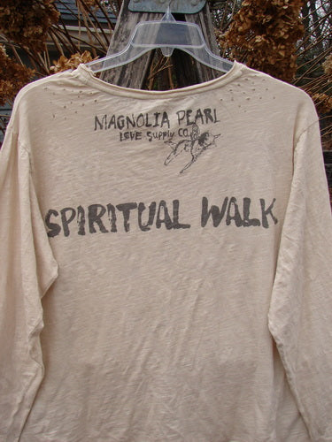 Magnolia Pearl NWT Cotton Jersey Boyfriend Tee Spiritual Walk Carousel OSFA, featuring MAGNOLIA PEARL LOVE SUPPLY CO. text, distressed details, soft beige fabric, and a unique wrap seam design.