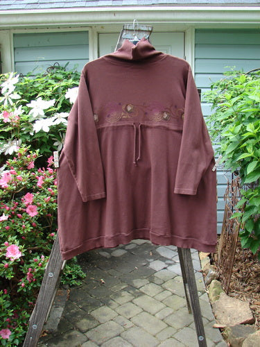 Barclay Interlock Turtleneck Pullover Tunic Top Celtic Paisley Sepia Size 2 displayed on a rack, showcasing its oversized fit, ribbed accents, and unique side entry pockets.