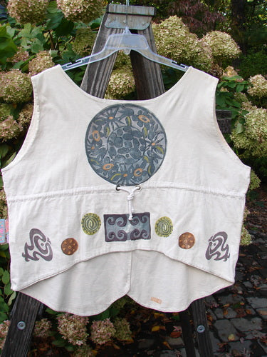 1993 The Vest Medallion Tea Dye Size 2, featuring blue and yellow flower designs, tuxedo-style front tails, and a draw-corded back with metal grommets, in oversized cotton.