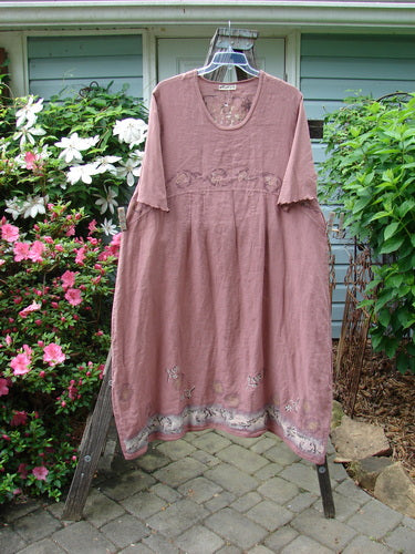 Barclay Linen Cotton Sleeve Banded Hem Pleat Dress Bird Gal Dusty Mauve Size 2 displayed on a rack, showcasing its pleated design and unique bird-themed rear panel.
