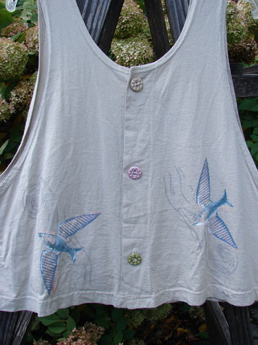 1999 Pinwheel Vest Love Dove Dust Size 2, featuring a white shirt with blue bird patterns, three porcelain buttons, deeper arm openings, a slightly flared hemline, and a cropped length.