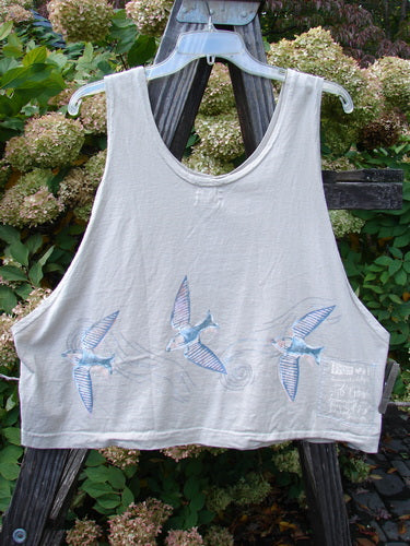 1999 Pinwheel Vest Love Dove Dust Size 2: White tank top with bird motifs, featuring three porcelain buttons, deeper arm openings, slightly flared hem, and cropped length. Made from organic cotton, perfect condition.