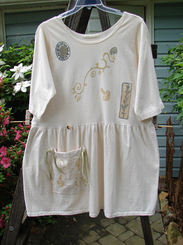 1994 Flower Garden Dress Sun Garden Tea Dye Altered Size 2 on clothes line, featuring a lowered pocket, scooped neckline, drop waist, and whimsical sun garden theme paint.