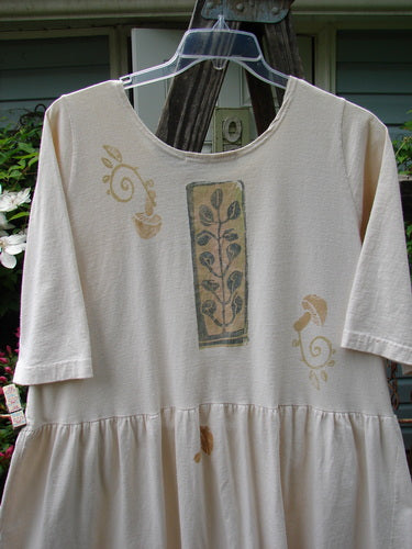 1994 Flower Garden Dress with floral design, scooped neckline, drop waist, and sun garden theme. Mid-weight cotton jersey, shortened length, relocated pocket. Ideal for garden parties, whimsical and natural.