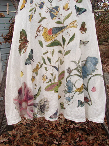 Magnolia Pearl NWT Cotton Jersey Lana Tank Dress Flor Da La Pasion True OSFA features a nature-inspired butterfly, bird, and botanical motif, with raw edges and a sweeping A-line shape hanging outdoors.