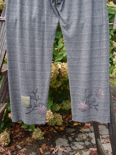 2000 Rayon Lycra Stripe Duo Cliffshadow Stripe Size 2 pants with floral design displayed on a wooden ladder.