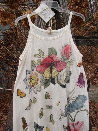 Magnolia Pearl NWT Cotton Jersey Lana Tank Dress features colorful butterflies and flowers. Displayed outdoors, it showcases raw edges and distressing, embodying Bluefishfinder.com's vintage, expressive style.