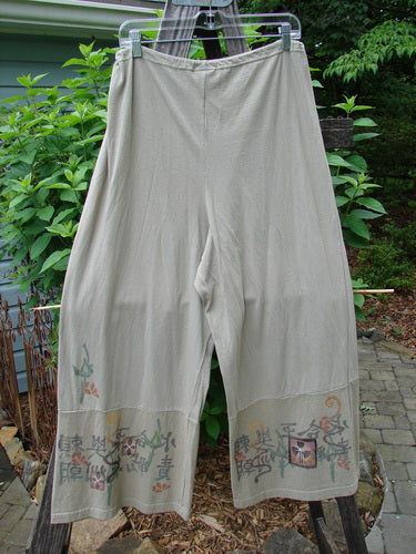Barclay Cotton Hemp Drawstring Cuff Bottom Pant Asian Inspiration Wheat Size 0, hanging on a clothesline, showcasing detailed Asian-inspired painted design and full draw cord waistline for perfect drape and movement.