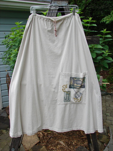 1994 Everywhere Skirt Magical Fish Mist Size 1, featuring a white cotton A-line design with a front pocket and drawcord waist, hanging on a clothesline.