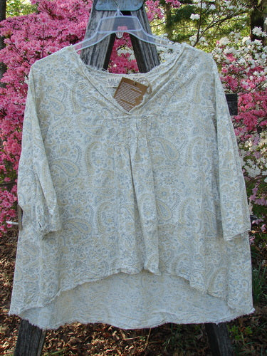 Magnolia Pearl NWT European Cotton Bondi Blouse Fleuri OSFA on hanger; features paisley print, scooped V-neck, three-quarter sleeves, pintuck accents, raw edges, and varying hemline, hung on rustic ladder.