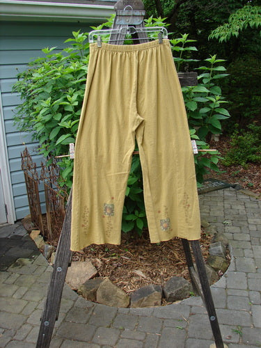 2000 Hemp Cotton Archive Pant Sun Gold Altered Size 0 hanging on a clothesline, showcasing sectional belled legs and a V-shaped front tummy section.