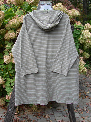 2000 Resort Hooded Pocket Pullover Zig Zag Black Olive Grey Stripe Size 2 displayed on a wooden rack, showcasing its A-line shape, oversized hood, and two offset front pockets.