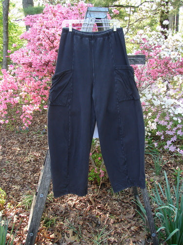 Barclay Interlock Cuff Toboggan Pant Unpainted Black Size 1 hangs on a ladder, showcasing elastic waist, oversized flap pockets, and fleece cuffs, embodying Bluefishfinder.com's vintage style and creative freedom ethos.