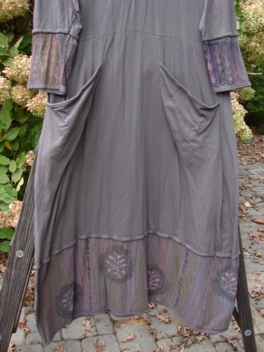 Barclay Pleated Banded Bottom Sweep Dress Celtic Fern Mushroom Size 1 on a stand, featuring pleated neckline, sectional painted sleeves, double exterior pockets, and detailed fern graphics.