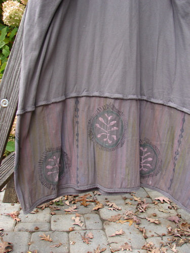 Barclay Pleated Banded Bottom Sweep Dress in Mushroom with a pleated front neckline, sectional sleeves, and fern graphics, showcasing double exterior pockets and an A-line shape.