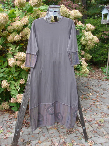 Barclay Pleated Banded Bottom Sweep Dress Celtic Fern Mushroom Size 1 displayed on a wooden stand, showcasing a pleated front neckline, painted sleeves, and a sweeping A-line shape with exterior pockets.