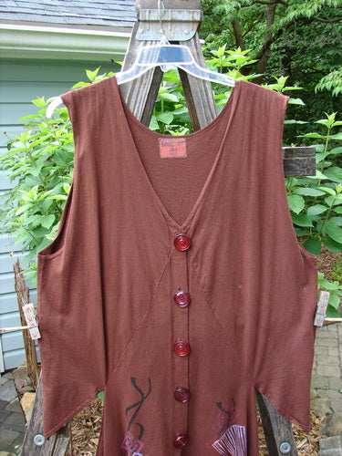 Barclay Calligrapher's Vest in Sepia with vintage buttons and Asian-inspired forest theme lines, displayed on a wooden fence.