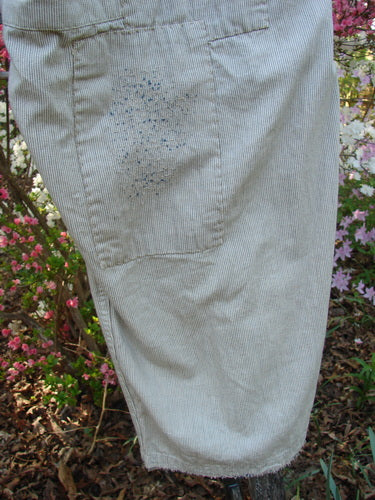 Magnolia Pearl NWT European Denim Lilou Trouser Natural Pinstripe OSFA features light pinstriped cotton with blue speckles on the thigh, showcasing adjustable elements and distressed, patched details, embodying Bluefishfinder.com's vintage-inspired aesthetic.