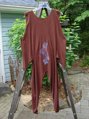 Barclay Calligrapher's Vest in Sepia displayed on a wooden ladder, showcasing a dramatic, open-hip design with vintage buttons and intricate Asian-inspired forest-themed details.
