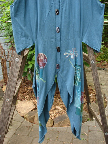 Barclay Calligrapher's Vest in Deep Tealen with Asian inspiration, featuring a dramatic shape, open hips, deep V-neckline, and vintage buttons, displayed hanging on a wooden ladder.