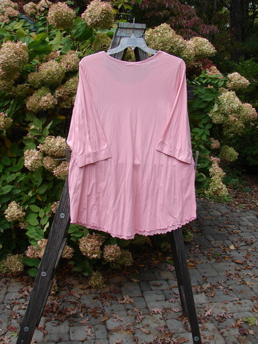 Barclay Twinkle Pocket Top, Size 2: A pink shirt with angular front pockets, banded lower sleeves, and a softly rounded A-line shape.
