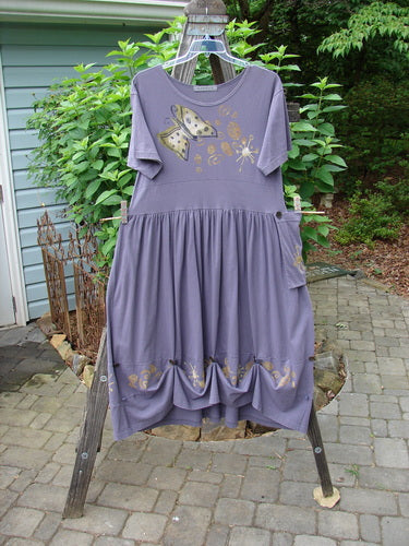 1996 Constellation Dress Butterfly Purple Martin Size 1, featuring a butterfly design, adjustable hemline with buttons, scooped neckline, and a full skirt, displayed outdoors.