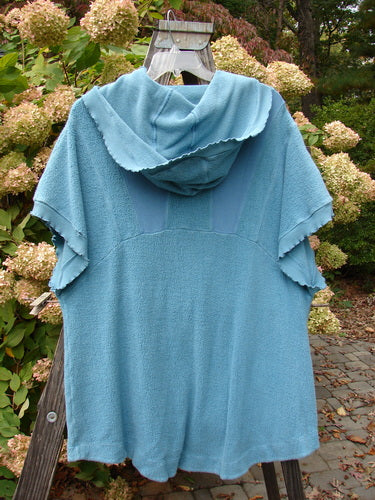 Barclay Celtic Moss Hooded Pocket Cardigan Unpainted Dusty Aqua Size 0 on display, featuring a floppy hood, short sleeves, two lower exterior pockets, and curly edgings.
