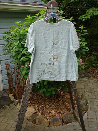 1998 Botanicals Robin's Top Platearius River Size 0 displayed on a rack, showcasing its A-line shape, dual front pockets, and 7 buttons, made from heavyweight linen.