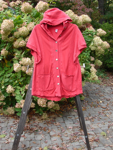 Barclay Celtic Moss Hooded Pocket Cardigan on a stand, showcasing its short sleeves, floppy hood, full button front, and two lower exterior pockets, highlighting its unique texture.