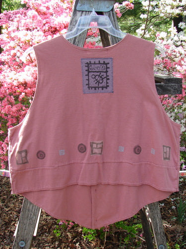 1995 Button Vest Village Russet OSFA: A sleeveless, dusty-rose vest with unique block-print motifs and gentle high-low hemline displayed in a garden, showcasing Bluefishfinder.com's vintage, expressive style.