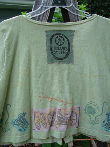 1993 Travel Top Beach Treasure Kelp Altered Size 2, featuring a deeply scooped neckline, crop shape, beach-themed paint, Blue Fish 93 patch on the back, and wooden buttons.