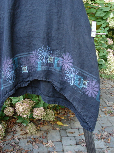 Barclay Linen Lace Pinafore Jumper Daisy Border Black Size 0 displayed hanging, showcasing its rounded neckline, lace accents, deep arm openings, and varying dip side hem.