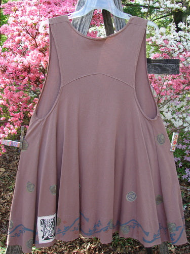 1993 Short Column Vest Floral Vine Rosewood OSFA displayed on a hanger outdoors. Featuring a swingy shape, abstract motif along the hem, and a signature Blue Fish patch, embodying vintage flair from Bluefishfinder.com.