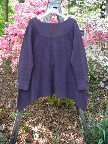 Barclay Patched Crepe Cross Over Tunic Top Diamond Brum Size 1 draped on a stepladder, showcasing its scooped yoke, asymmetrical hem, and three-quarter sleeves, highlighting the textured stretch cotton crepe fabric.