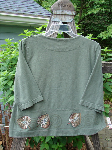 2000 4 Corners Jacket Leaf Green Lake Size 0: Organic cotton jacket with a cropped, flared shape, featuring leaf patterns and original floral buttons, perfect for layering and a playful, swinging silhouette.