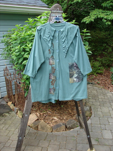 1994 Falling Leaves Jacket Asian Leaves Deep Sea Altered OSFA displayed on a clothing rack, featuring a uniquely stitched pointed collar, wider neckline, and original Blue Fish buttons in excellent condition.