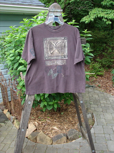 1995 Short Sleeved Tee Butterfly Madderlake Altered Size 2 displayed on a hanger, with a butterfly design, drop shoulders, and a thicker ribbed neckline, offering a slightly shorter, boxier shape.