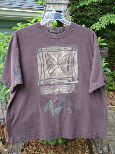 1995 Short Sleeved Tee Butterfly Madderlake Altered Size 2, features a butterfly design, drop shoulders, and a ribbed neckline. This vintage tee has a slimmer fit and is made from organic cotton.