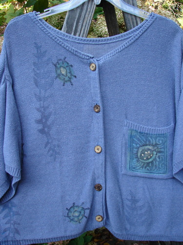 1995 Cotton Rayon Short Sleeved Cardigan Sweater Friendly Garden Dusk Mélange Size 3, featuring colorful buttons, varied textures, and a garden critter theme. Classic ribbed neckline and wide short sleeves.