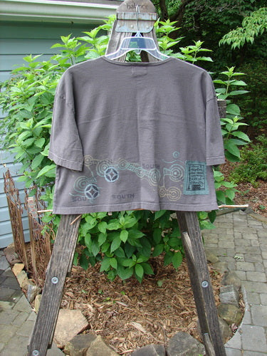 2000 City Side Crop Tee Top Go South Iron Size 1 displayed on a wooden stand, featuring wide swingy shape, rolled neckline, and distinctive painted design.