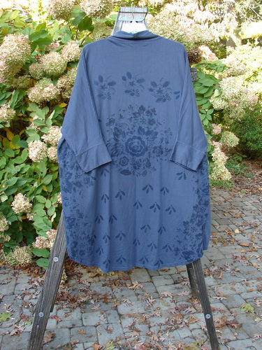Barclay Bamboo Dolman Day Jacket in Navy with Vintage Floral Design, featuring an open front, two exterior pockets, cuffed sleeves, and a rounded rear hemline, displayed on a stand.