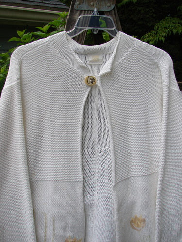 1999 Rollneck Cardigan Sweater Pastel Tulip Pure White OSFA displayed on a swinger, showcasing dual knitting, sectional rolled seams, cropped back, and double shiny porcelain buttons in perfect condition.
